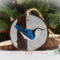A 3.5 inch diameter wood slice with a hand-painted blue and white bird at Cove Creek Photography.